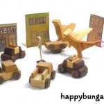 wood dinosaurs cause havok with wooden toy cars in play scene