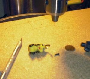 tiny plastic ladybug undergoing antennae repair